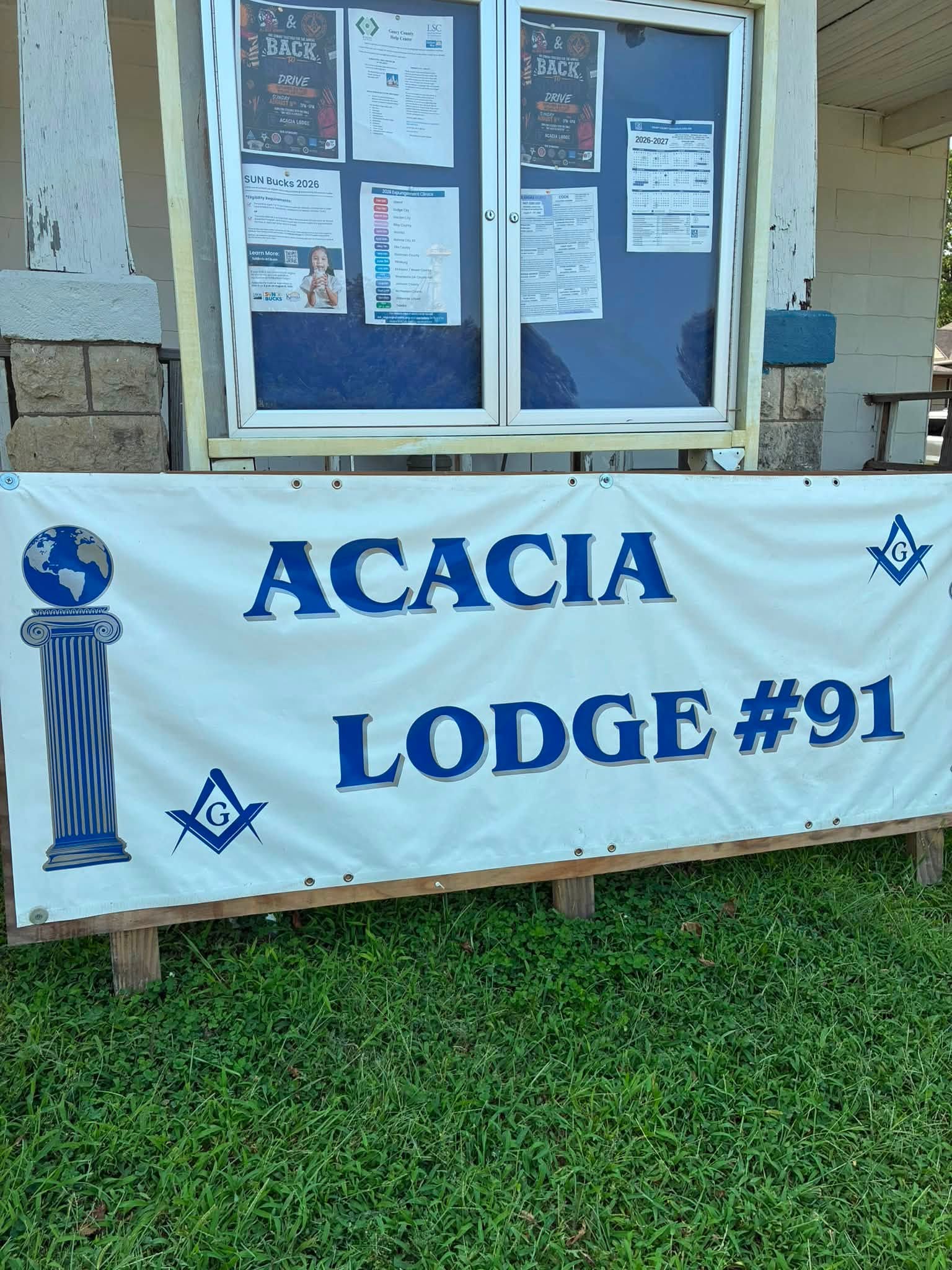 The Acacia Lodge No. 91 banner displayed beside community information during the event