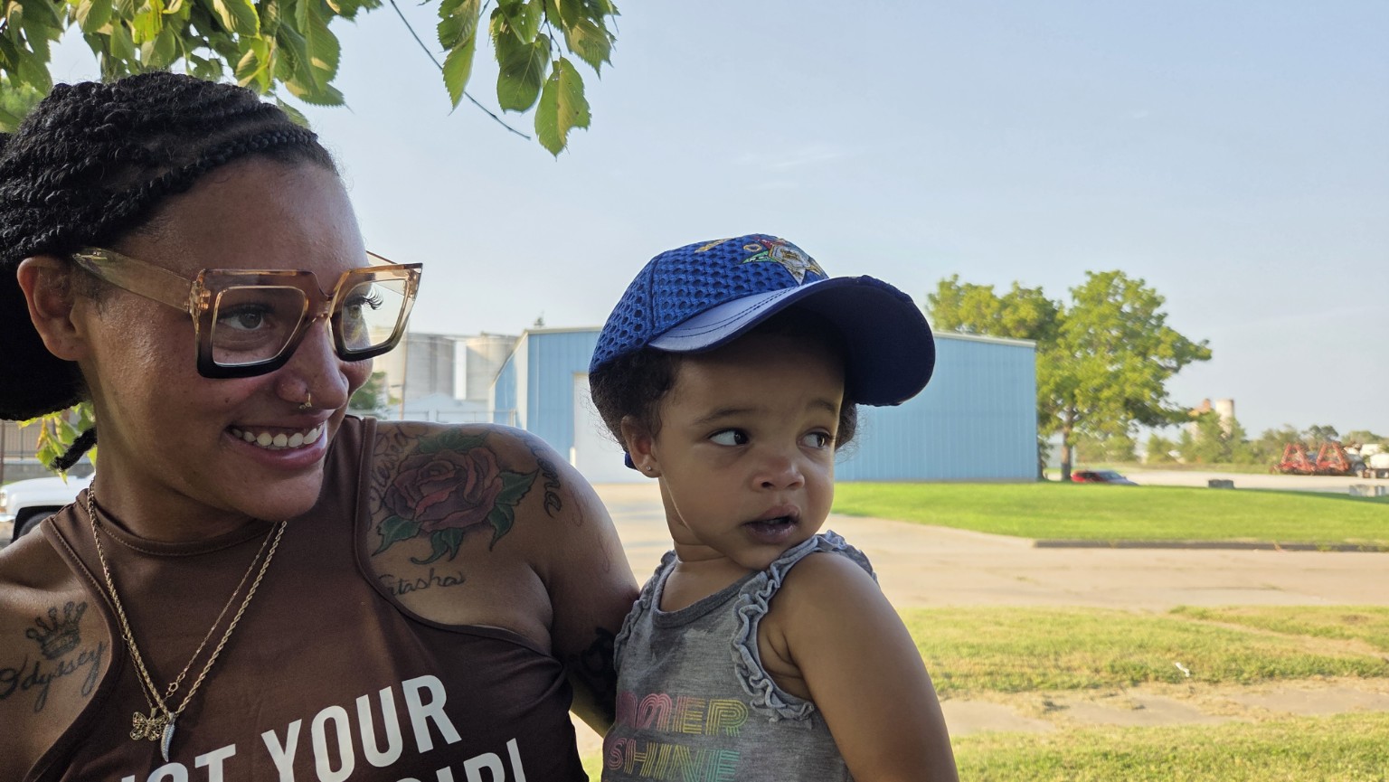 A mother smiles with her young child during the community celebration
