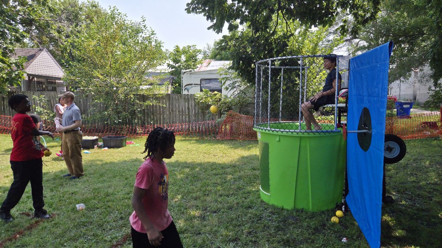 A young guest throws a ball toward the dunk tank during the Back-to-School Drive