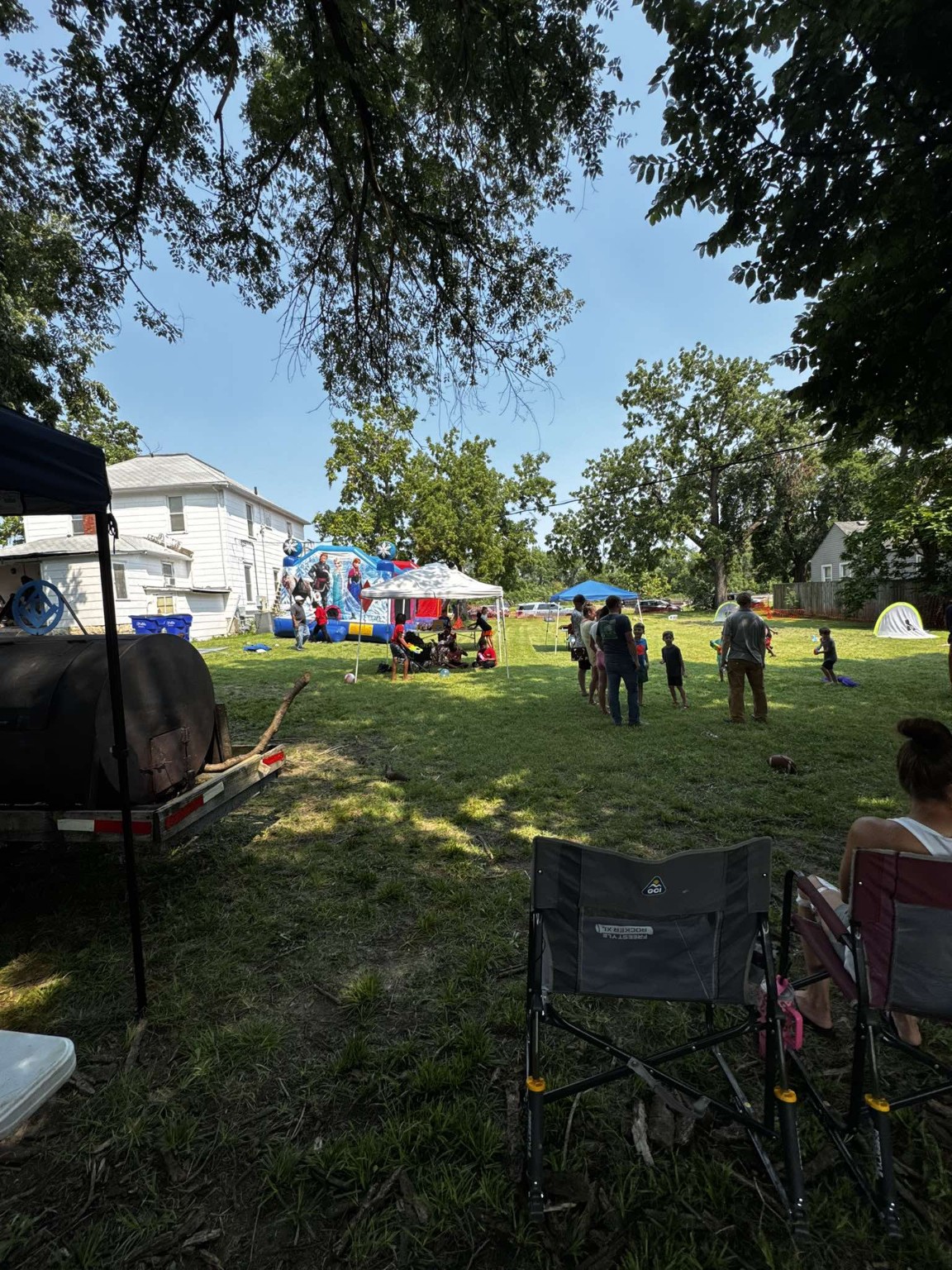 Families enjoy the bounce house and activities across the Acacia Lodge grounds