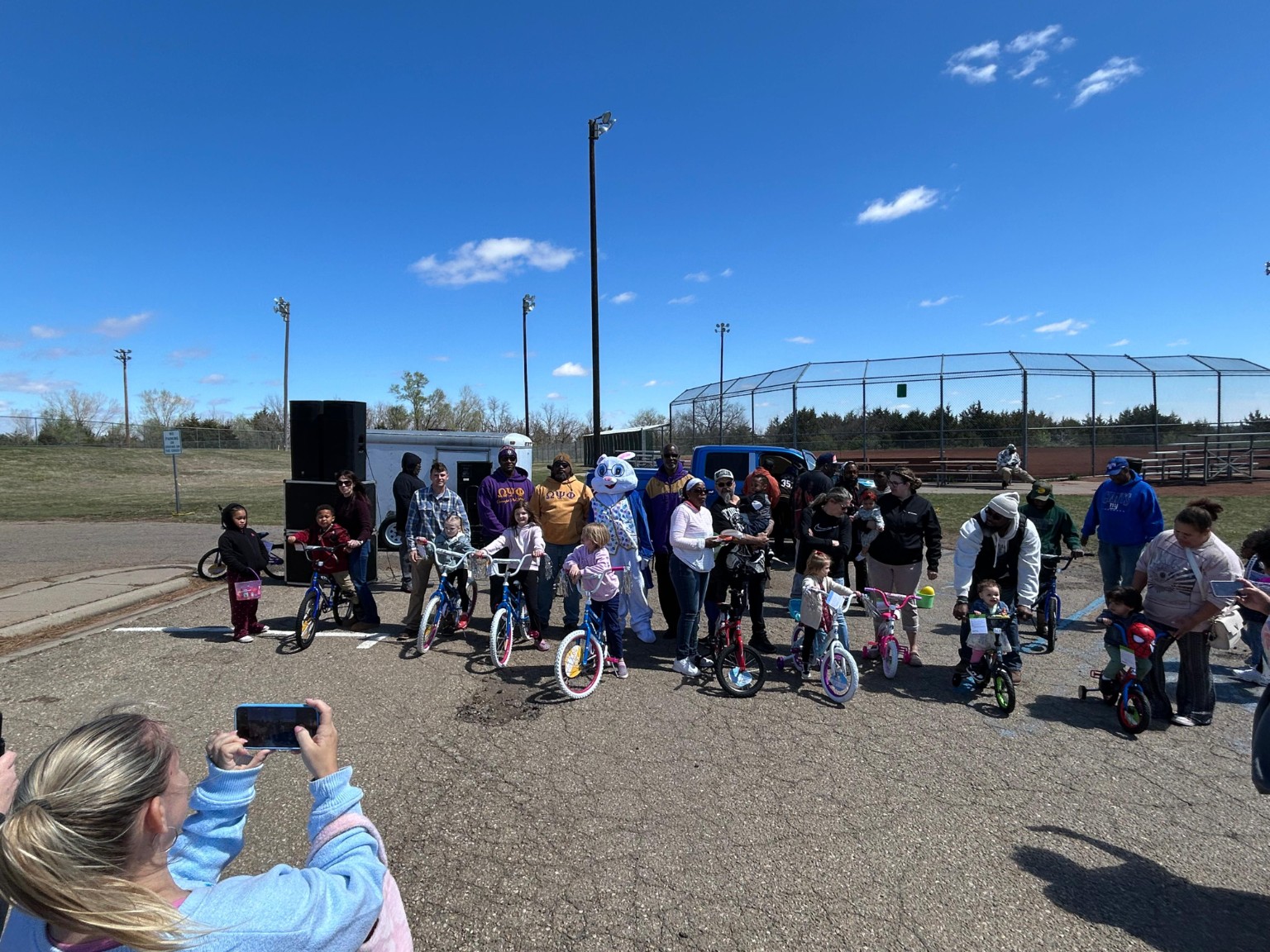 Children and families gather with their new bicycles during the Easter celebration