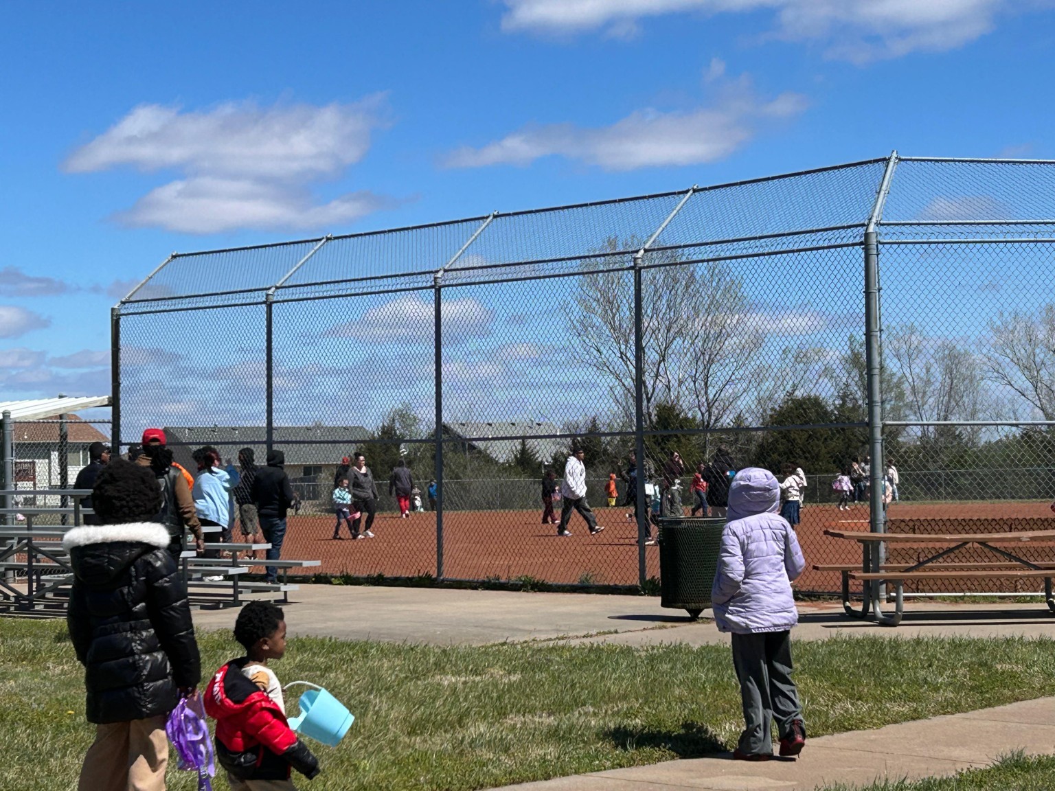Children and families enjoy the Easter egg hunt on the field