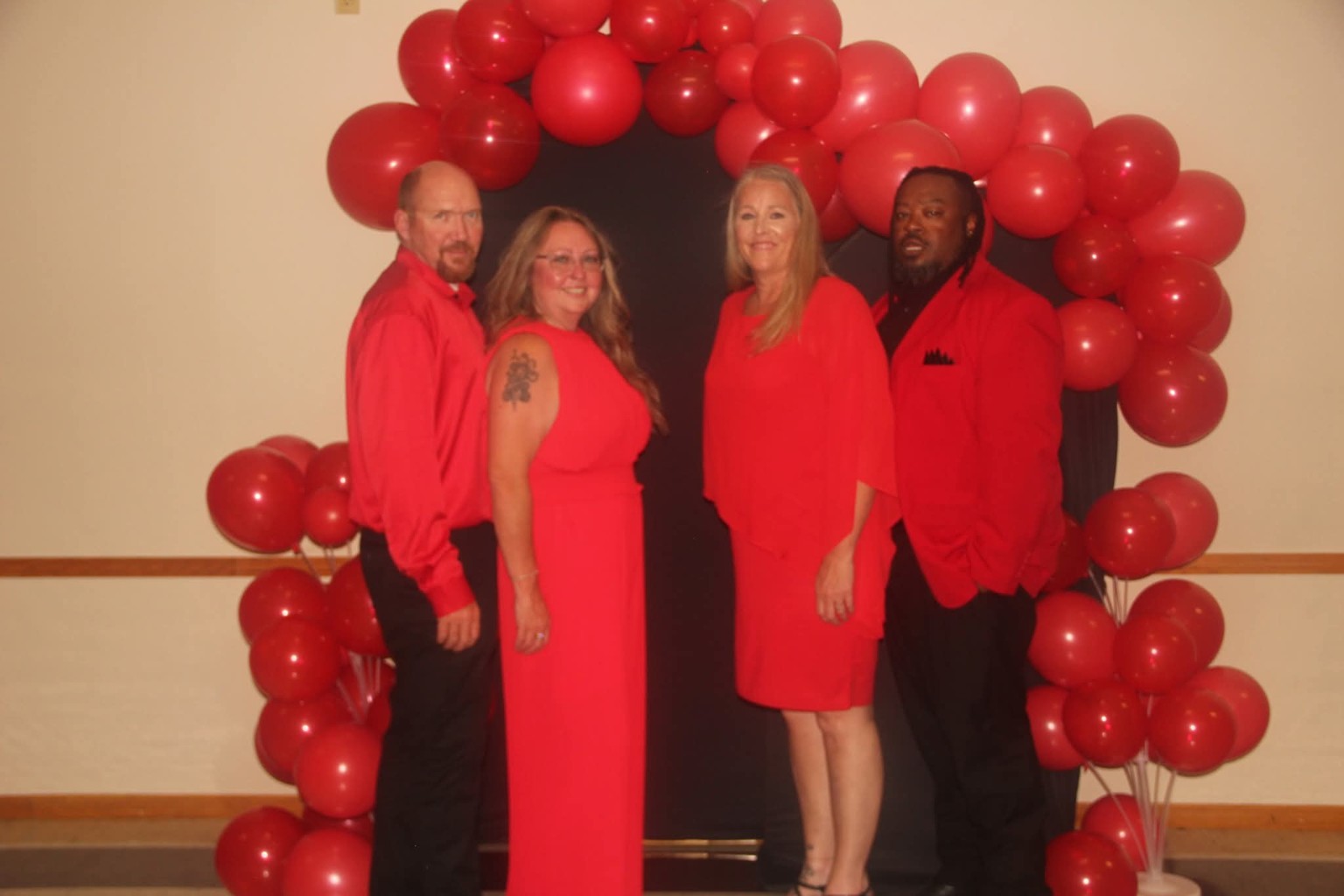 Guests pose beneath the red balloon backdrop at St. Tabitha Chapter No. 75's Annual Red Dance
